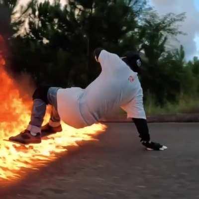 Skater slides beautifully through a wall of fire