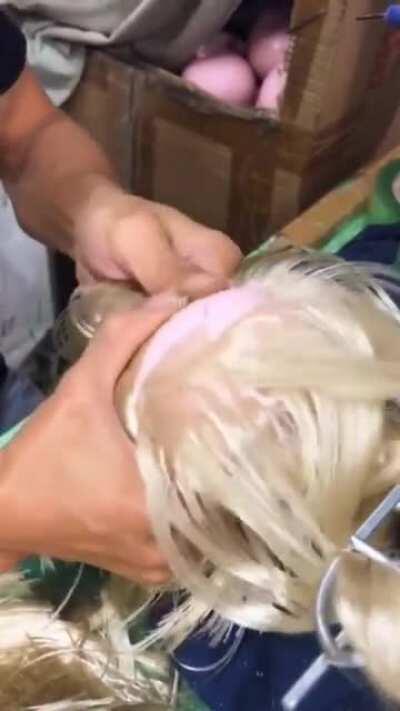 Stitching on hair to a doll