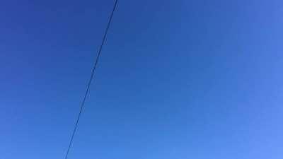 a wire and a road sign in the blue sky (Leninskiy Prospect, Saint Petersburg, RU)