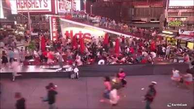 Panic in Times Square after a backfiring motorcycle is mistaken for a gun