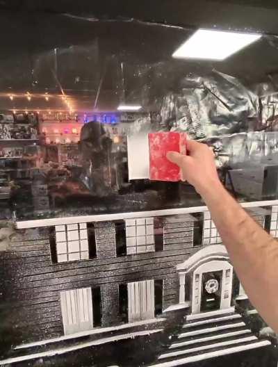 spray-snow artist creating Home Alone on a window (@snow.graffiti.scott) 