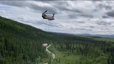 An Alaska Army National Guard CH-47 Chinook helicopter airlifting the 