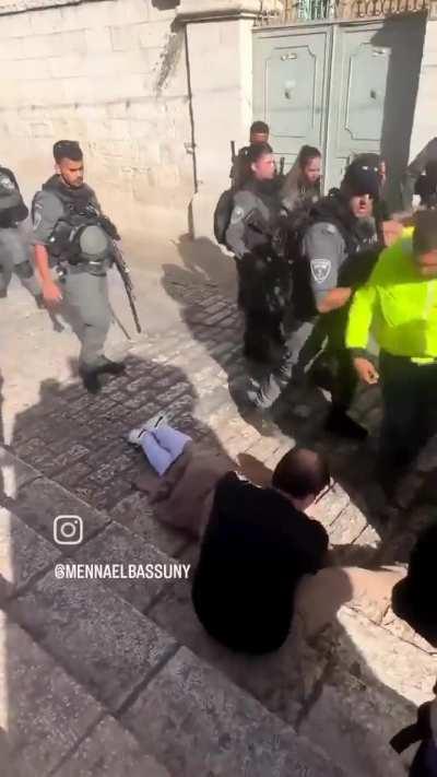 Police man pushing an old man