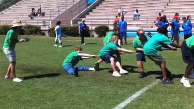 What could could go wrong if I sit down during tug-of-war?