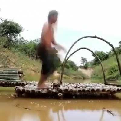 Two men building a shed on the water