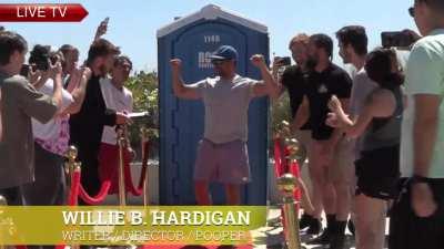 Sneaking a red carpet and cameras in front of a porta potty to surprise people as they come out