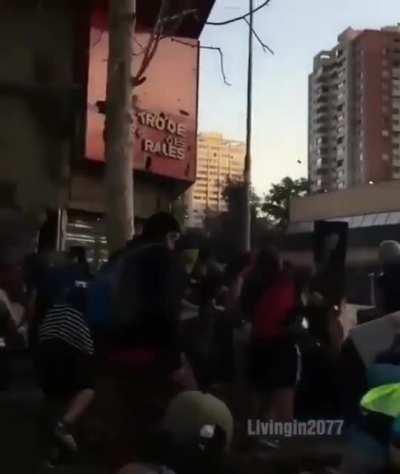 Man with saxophone plays during a protest in Chile