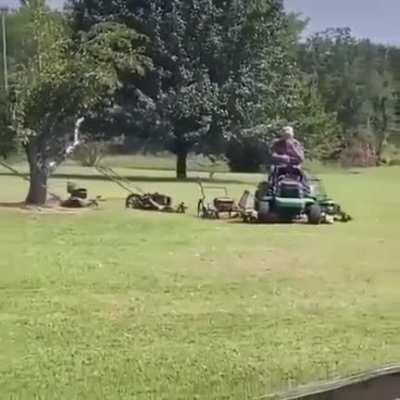 This guy has rigged up a whole army of mowers to keep his lawn looking great