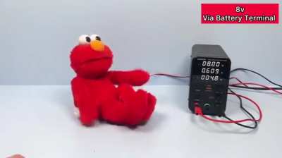 An Elmo toy under increasing voltage