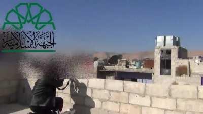 Two rebel fighters fire rifle grenades into an adjacent building that detonate on impact, Damascus [Syria] (November 2013)