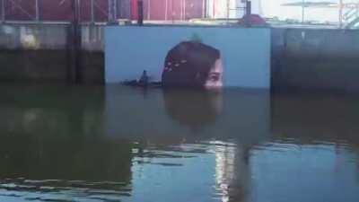 This artist had to take advantage of the low tides to be able to paint this mural.