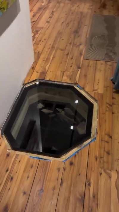 They found an old well hiding under the floor and made it into a feature.