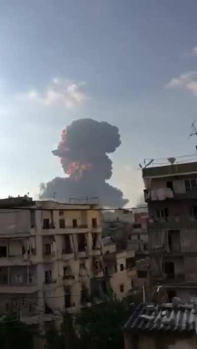 Video show massive explosion at port in Beirut, buildings damaged several kilometers away.