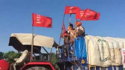 Millions of Indian farmers are protesting against the current regime's oppressive policies. The red flags are in front line. Goosebumps moment.