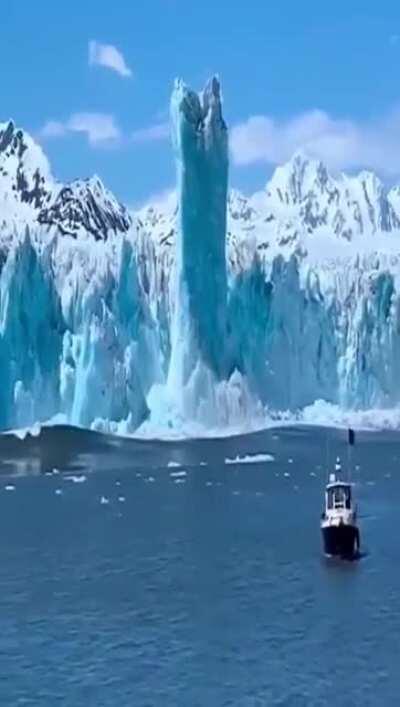 When the iceberg falls off the cliff, it sinks due to momentum, but because the density of iceberg is less and the seawater is heavier, the iceberg instantly resurfaces, floats to the surface and continues to rise upward, forming a pillar!