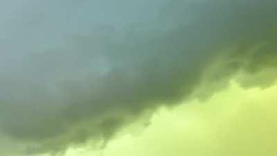 Video of the green sky behind the wall cloud as it passes Sioux Falls, SD