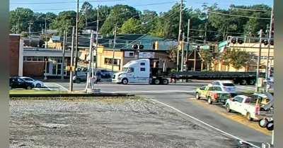 The dramatic train-truck collision was caught on video Tuesday morning in Cobb County, Georgia.