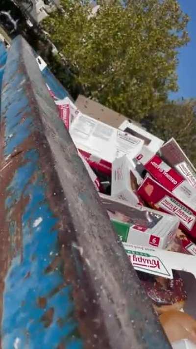 A dumpster full of Krispy Kreme doughnuts.