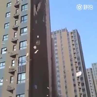 Using discount siding/adhesive on 20 story apartments.