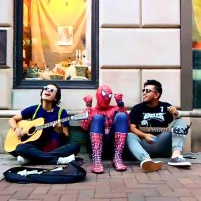 Found Spider-Man taking a break with some street musicians.