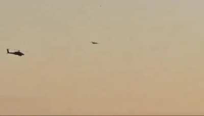 Israeli Helicopter looking for signs of possible Hezbollah drone infiltration, with the drone flying at its rear. Sirens sound after Helicopter sees drone. Nahariyya, Israel. 