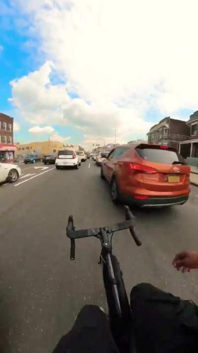 Cyclist Sideswipes Someone’s Car in Traffic 🤡 