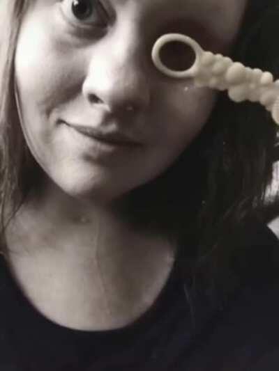 this girl blowing bubbles with her missing eye