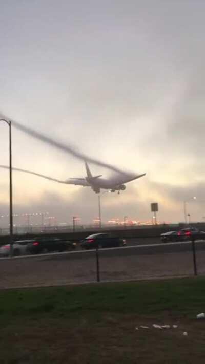 An Airplane emerging from fog