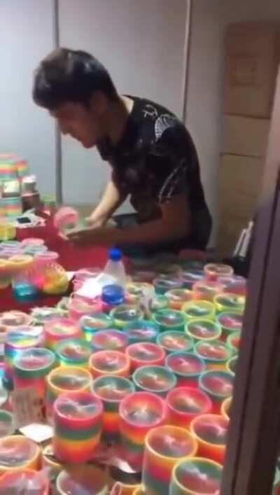 This guy knows how to play with Slinky Rainbow Toy.