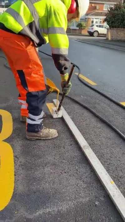 Road letters being painted in the UK