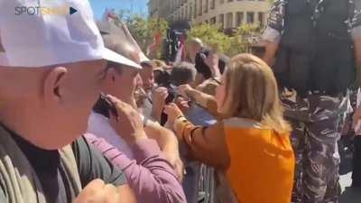 MP Paula Yacoubian handing over a 10$ necklace to a protester when the latter asked her if the necklace she's wearing was real gold.