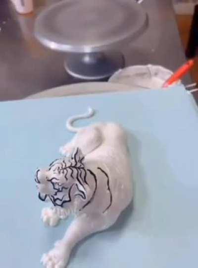 Using cream to create a tiger figurine