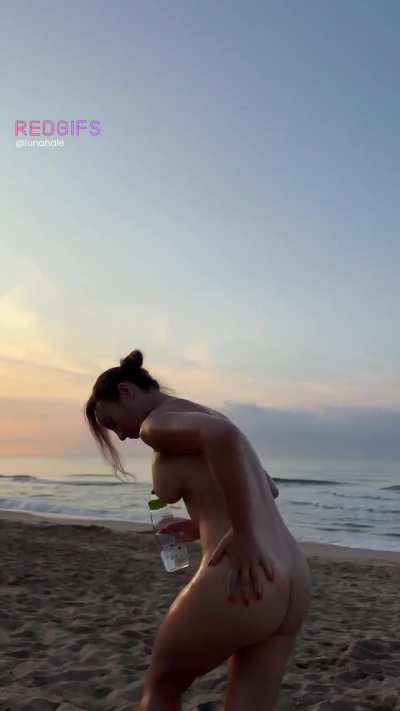 Oiling myself up on a public beach, completely naked