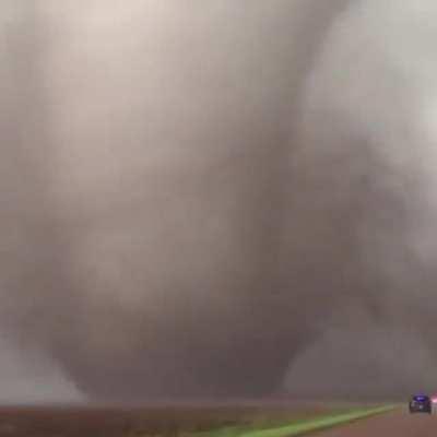 An absolutely massive tornado ripping through the countryside