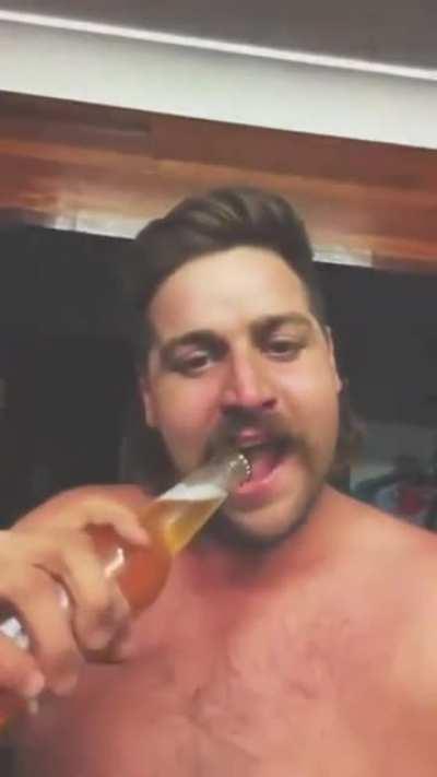 Guy flips a cigarette and then opens a beer bottle with his teeth