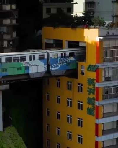 A train through residential apartments in China.