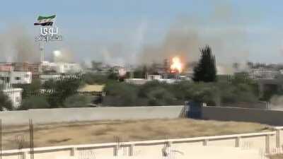 Cameraman remains remarkably calm as a Syrian MLRS strike comes down around him on the town of Nawa - 5/16/2014