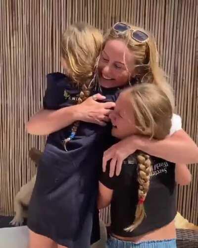 Daughters being reunited with their mom after 9 weeks of being away so she could provide medical care to patients