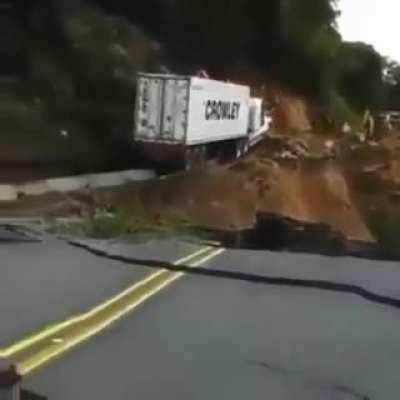 Trucker completely disregards washed-out mudslide to deliver the goods