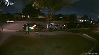 An epic lightsaber battle just happened in front of my house.