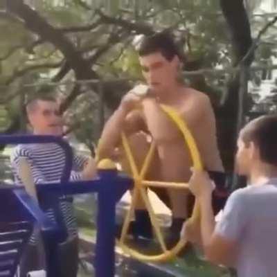 Going for a spin on the playground equipment in the wrong way