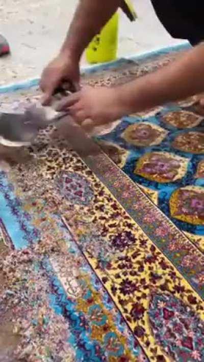 Shaving a faded Persian rug by hand