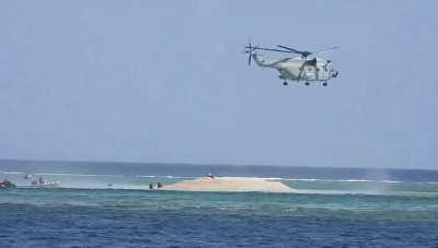 People's Liberation Army Navy Helicopter uses it's downdraft to physically blow away a Philippine Bureau of Fisheries and Aquatic Resources scientific survey team on an ocean feature well within the Philippine's Exclusive Economic Zone, that the PRC claim