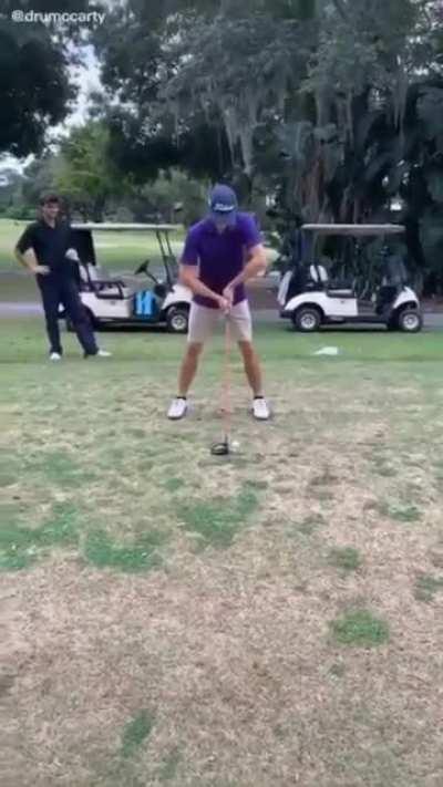 This guy has a unique golf swing.