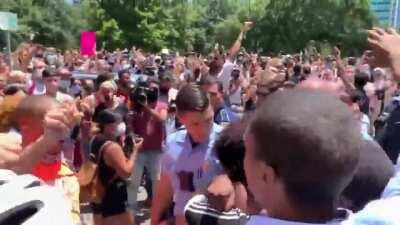 A black woman was detained at the New Orleans protests today. Then the crowd surrounded the police car until they let her go.