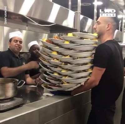 Waiter carrying 33 plates of food !!