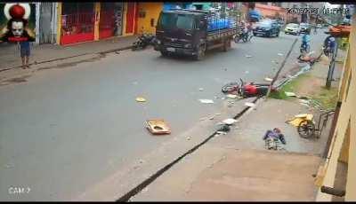 Motorcyclist crashes into a man pushing a cart