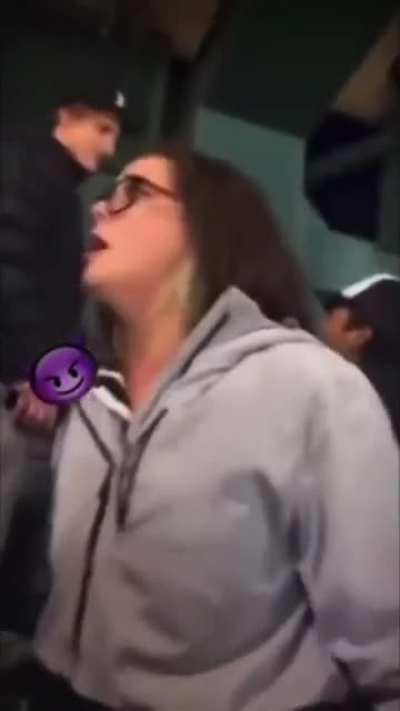 Woman gets mad at chick flashing her breasts at a sports event, gets booed and beer thrown on her