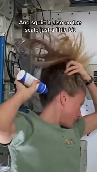 Karen Nyberg demonstrating how to wash long hair in space.