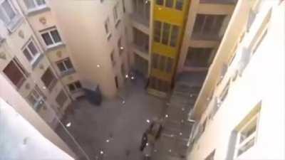 dumping a bucket full of paper airplanes from a building